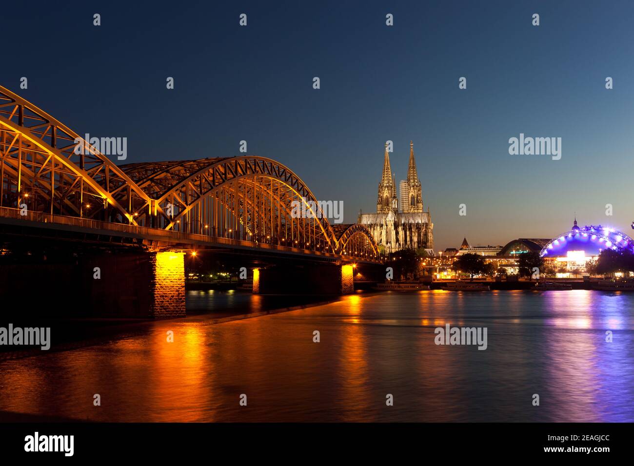 Cologne Cathedral and Hohenzollern Bridge at dusk Stock Photo