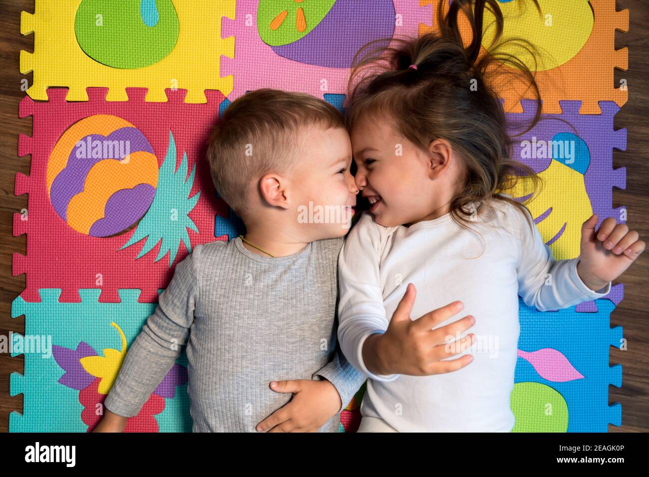 childhood, family friendship, games - close up portrait Two funny joy happy smiling little toddler peschool kids siblings twins brother with sister Stock Photo