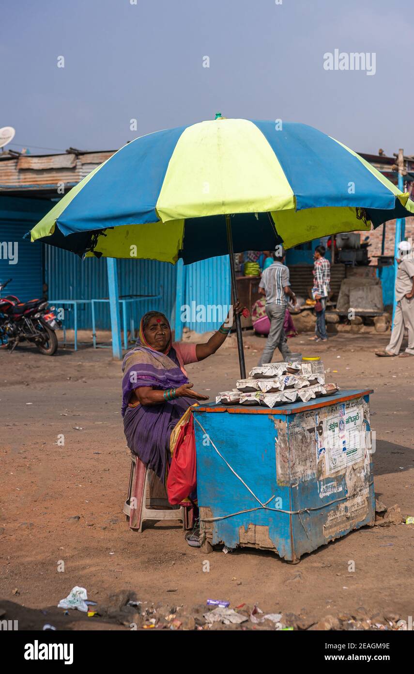 Kolhari, Karnataka, India - November 8, 2013: Roadside booth where female vendor sells home-made small cups of Chhena, a curd style resembling yoghurt Stock Photo
