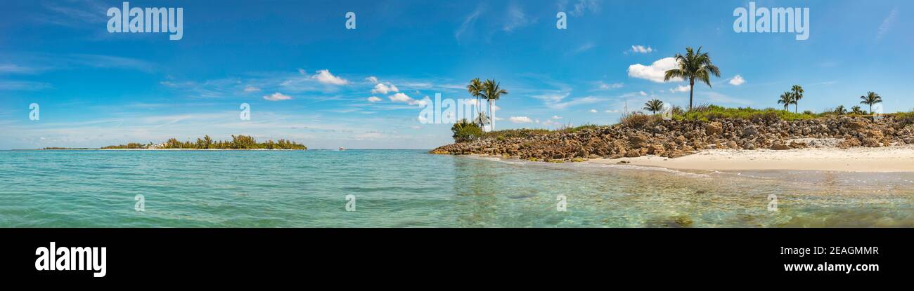Captiva Island and Redfish Pass from the seaside, turquise water, islands with stones, bushes and palmes, over all blue sky with white clouds, Panoram Stock Photo