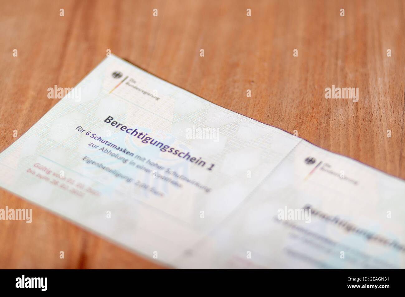 Stuttgart,Germany- February 09.2021:Closeup of german government entitling certificate for ffp2 protection masks purchase warrant Stock Photo