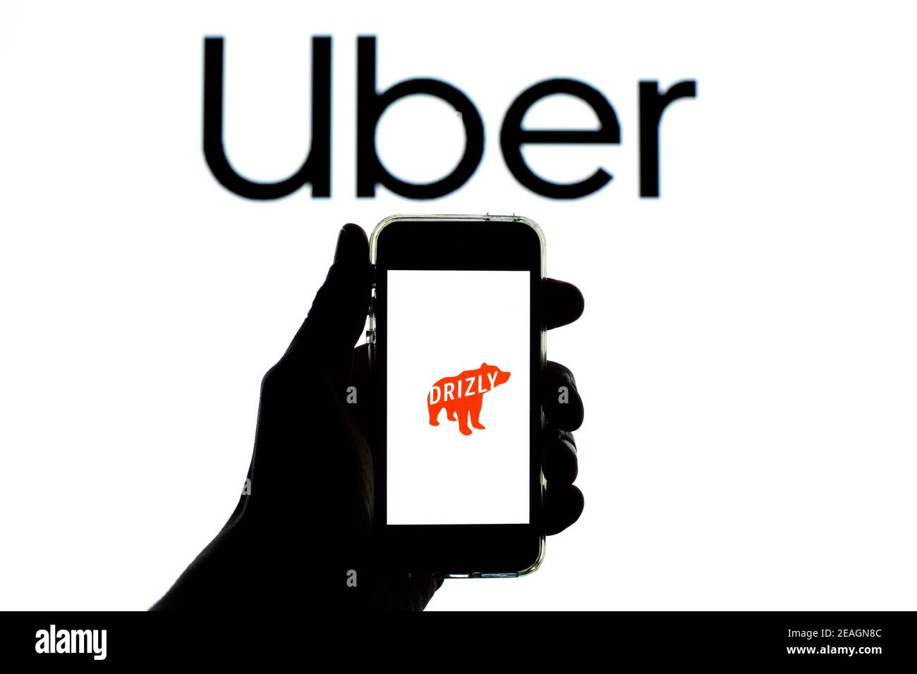 Barcelona, Catalonia, Spain. 9th Feb, 2021. In this photo illustration a Drizly logo is seen displayed on a smartphone with the Uber logo in the background. Credit: Thiago Prudencio/DAX/ZUMA Wire/Alamy Live News Stock Photo