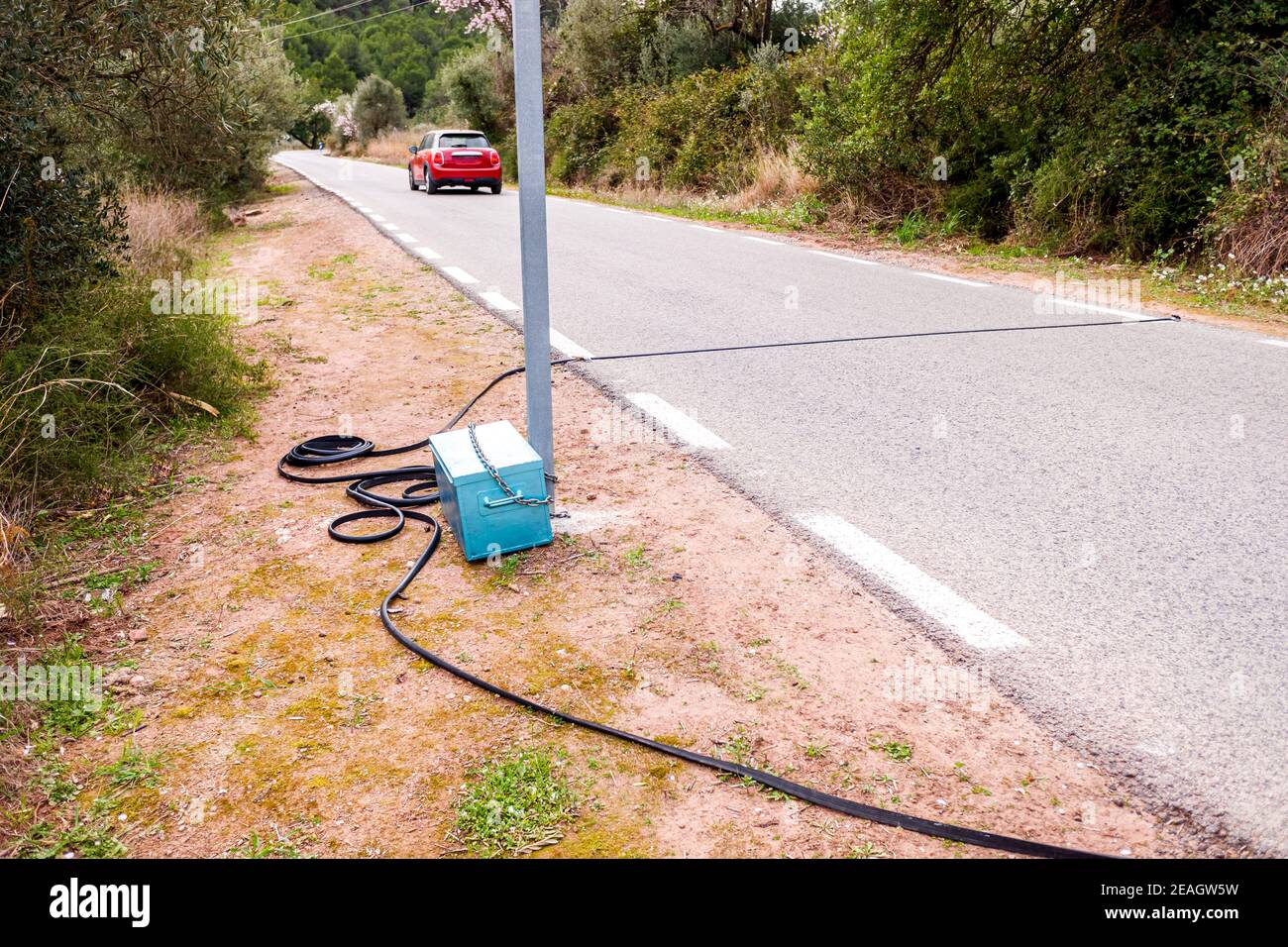 Black pneumatic tube along the road to measure speed and number of
