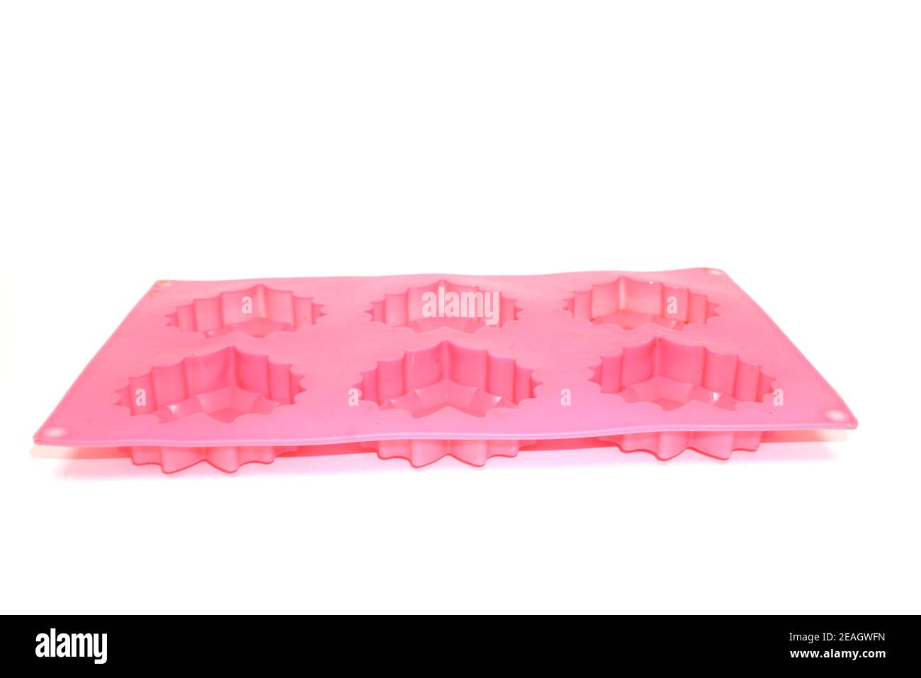 Pink used silicone cupcake mold isolated on white background Stock Photo