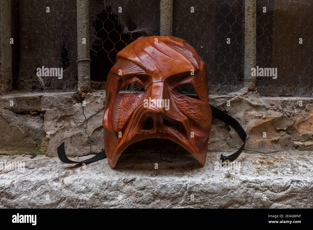 Leather theatre mask made by artist Carlo Setti from Venice. Mask portrays an elemental stone warrior with a rugged and scarred face. Stock Photo