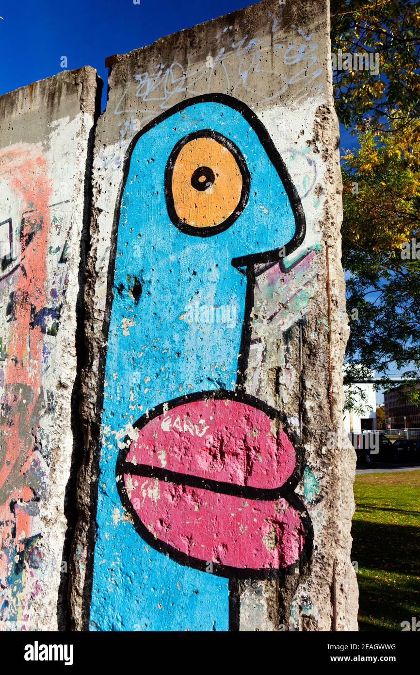 Berlin, Germany Berlin Wall segment with painted cartoon faces by