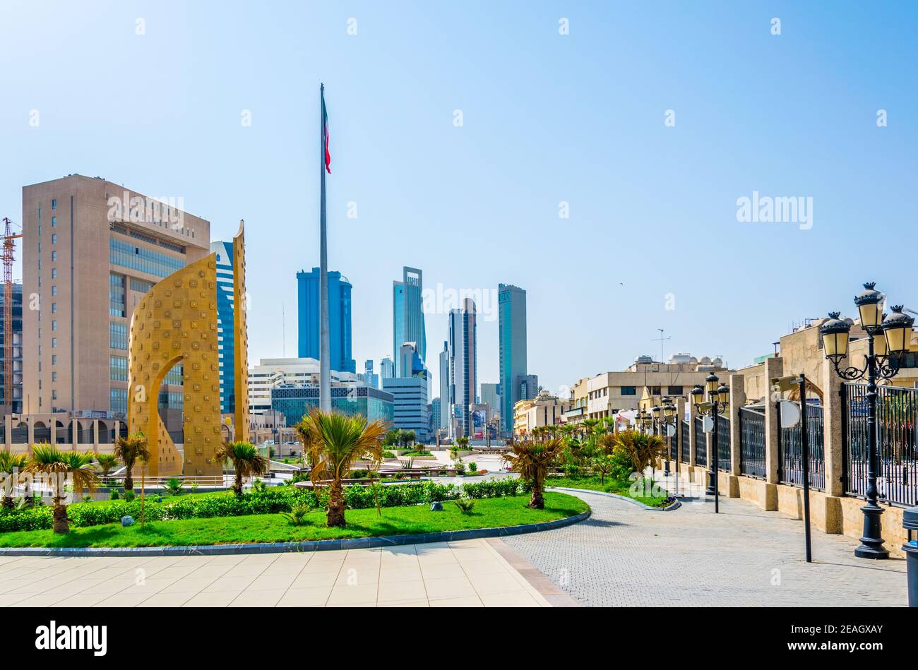 View of a a golden monument with a small park in the central Kuwait. Stock Photo