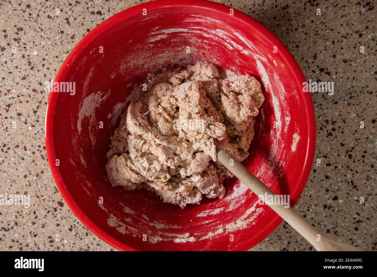 Mixing a bowl of ingredients for making bread. Series step-by-step making homemade bread.  Frame 3 of 13 Stock Photo