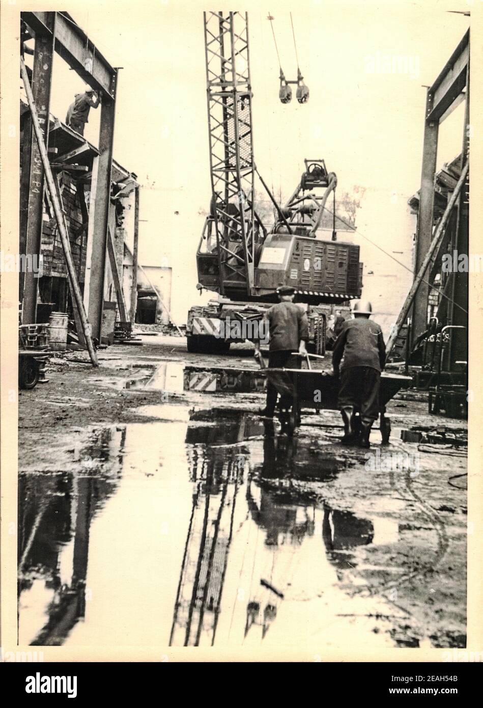FRAUREUTH, EAST GERMANY - MAY 20, 1965: The retro photo shows construction site in Communist bloc. Historical mobile crane. Former East Germany, 1960s Stock Photo