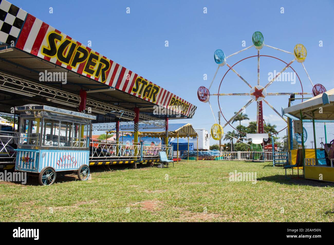 Ibitinga, SP, Brazil - 02 07 2021: Pop corn stand, bumper cars, carousel and big wheel at an amusement park Stock Photo