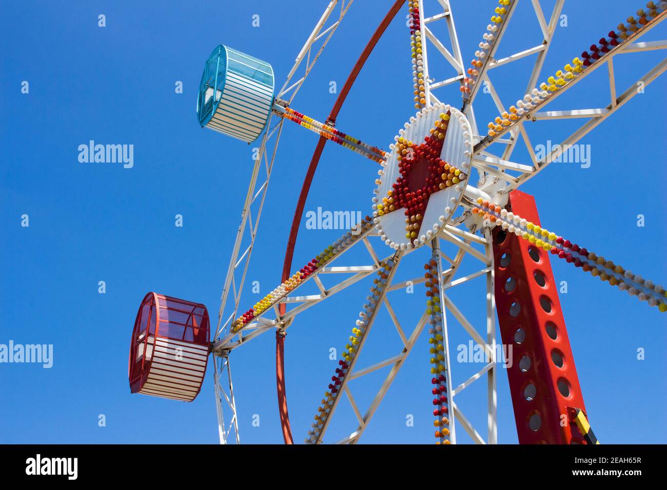 Big Wheel detail with two seats at amusement park. Blue sky on summer day. Stock Photo