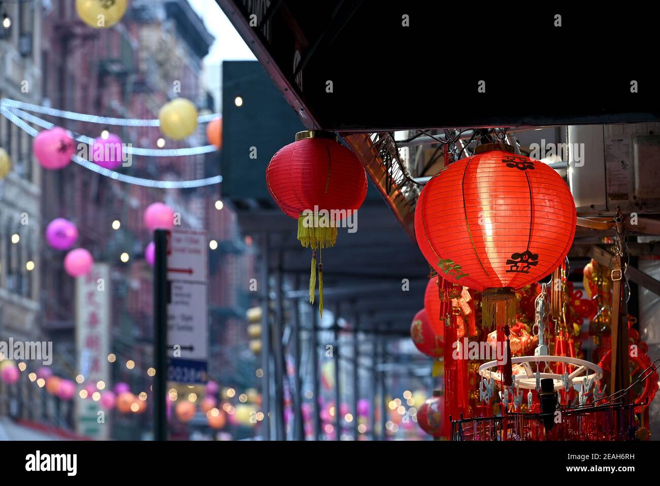 New York, USA. 09th Feb, 2021. Decorative lanterns hang above Mott street in Manhattan's Chinatown district before the start of the Chinese Lunar New Year, New York, NY, February 9, 2021. Members of the Chinese community and other asian cultures will celebrate the Chinese Lunar New Year, the year of the OX, starting on February 12, and lasting through January 31st, it is considered the most important holiday in China. (Photo by Anthony Behar/Sipa USA) Credit: Sipa USA/Alamy Live News Stock Photo
