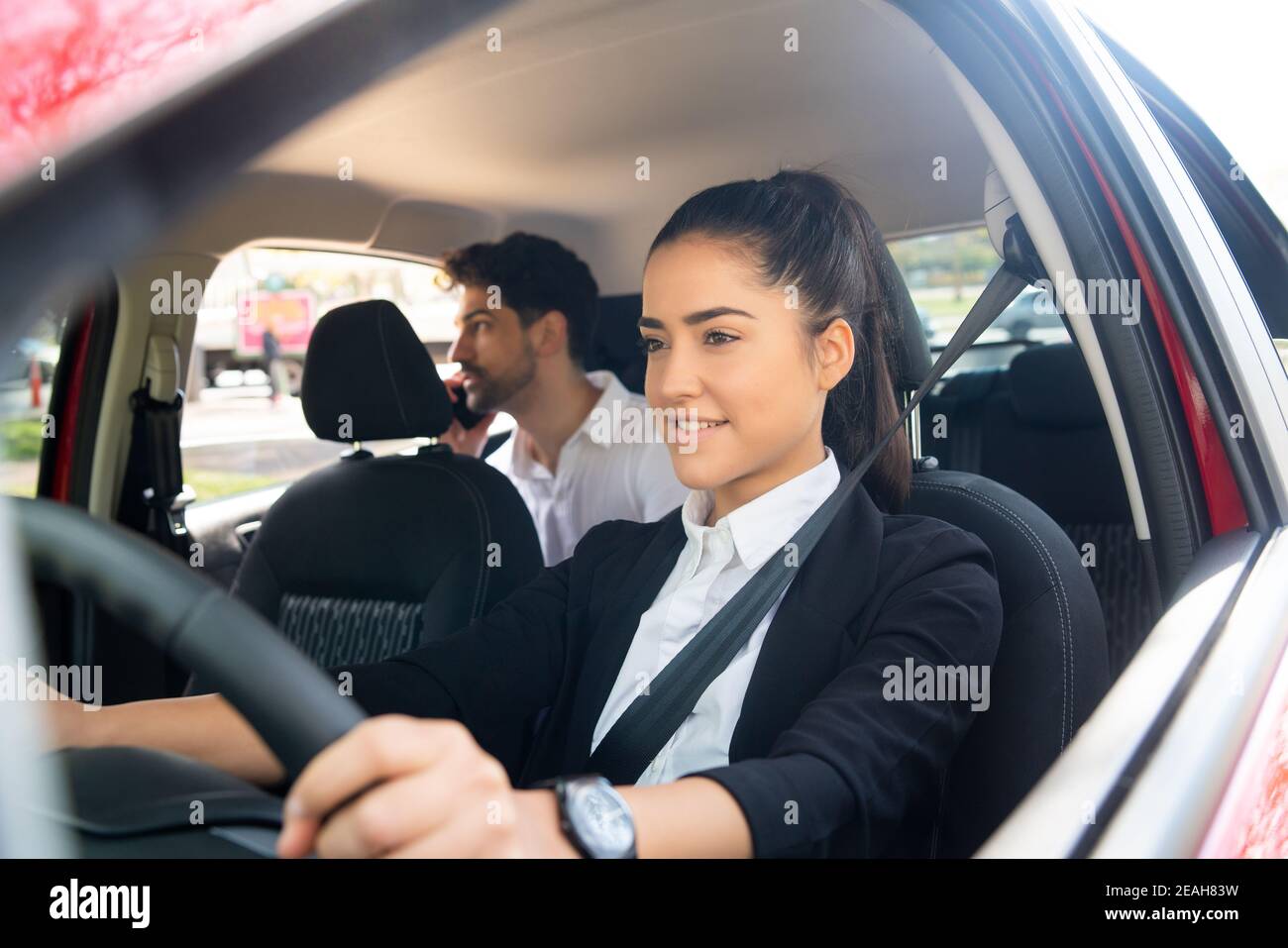 Taxi driver with passenger at back seat Stock Photo Alamy