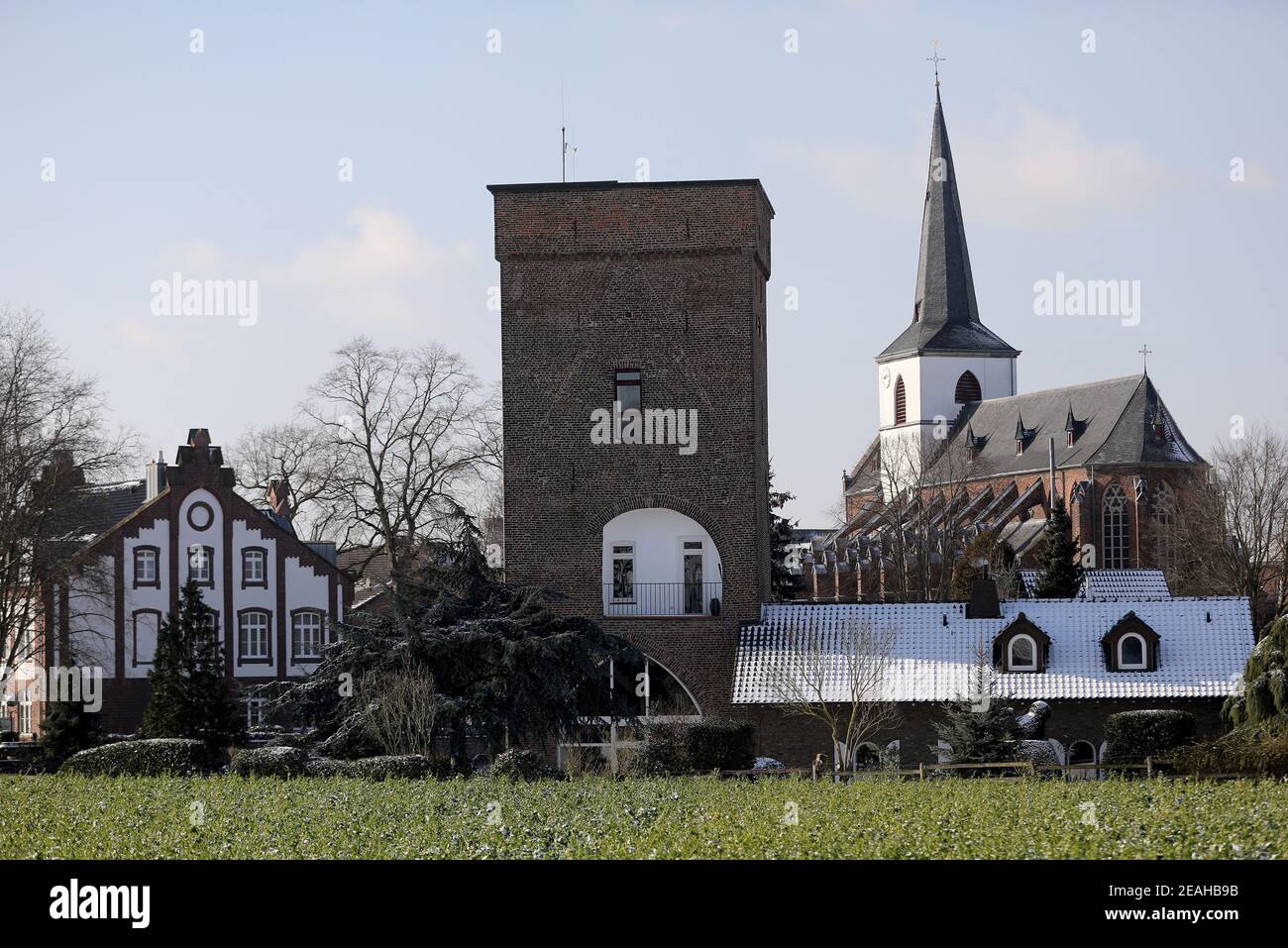 Gangelt, Germany. 09th Feb, 2021. The St. Nicholas Church can be seen  through the town gate. A year ago, Gangelt in the Heinsberg district became  famous overnight. The small town was one