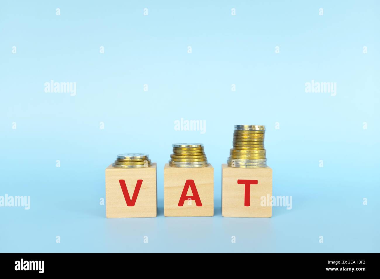 VAT letters on wooden blocks in blue background increasing stack of ...