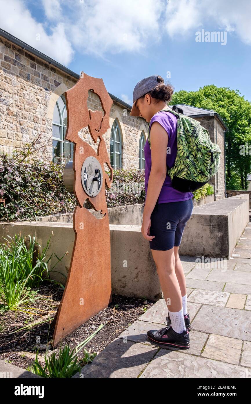 Teenager listens to interactive audio exhibit at Blaenavon World Heritage Centre, Blaenavon, Wales, GB, UK Stock Photo