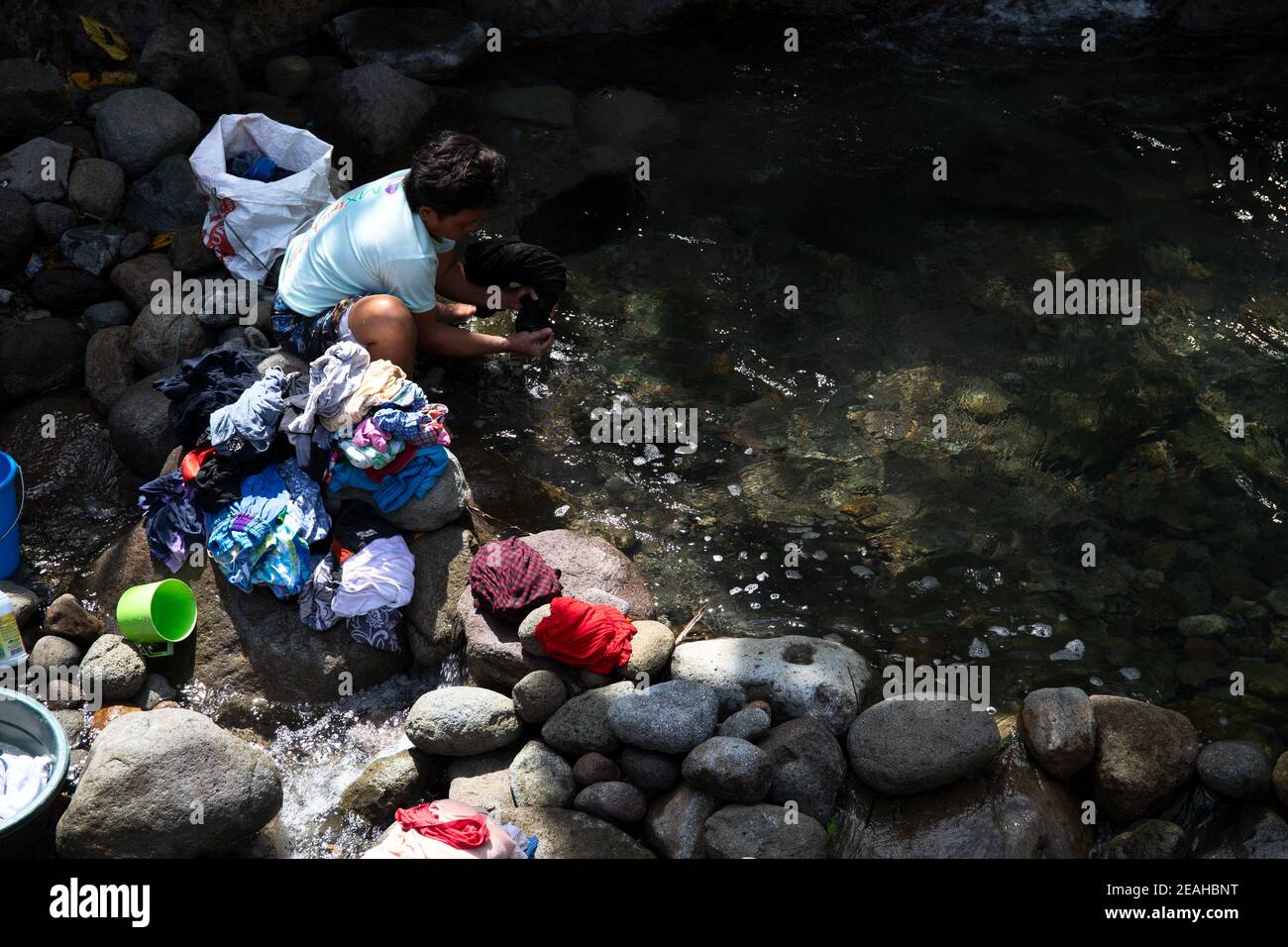 Dumaguete, the Philippines 23 Jan 2021 woman washing clothes in