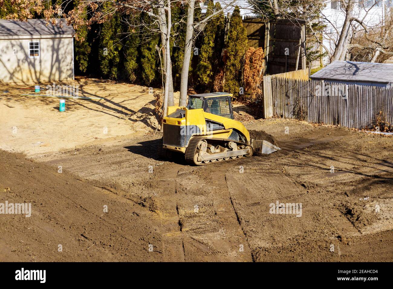 Bulldozer moving, leveling ground at construction site in ground using shovels Stock Photo