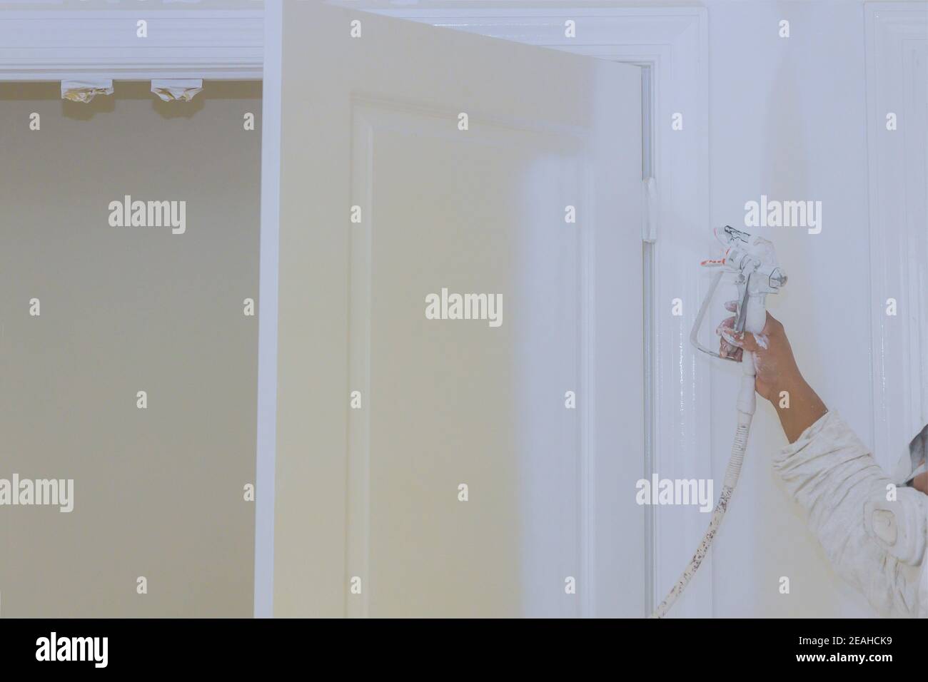 Master painting wood doors with spray gun processing painting base door