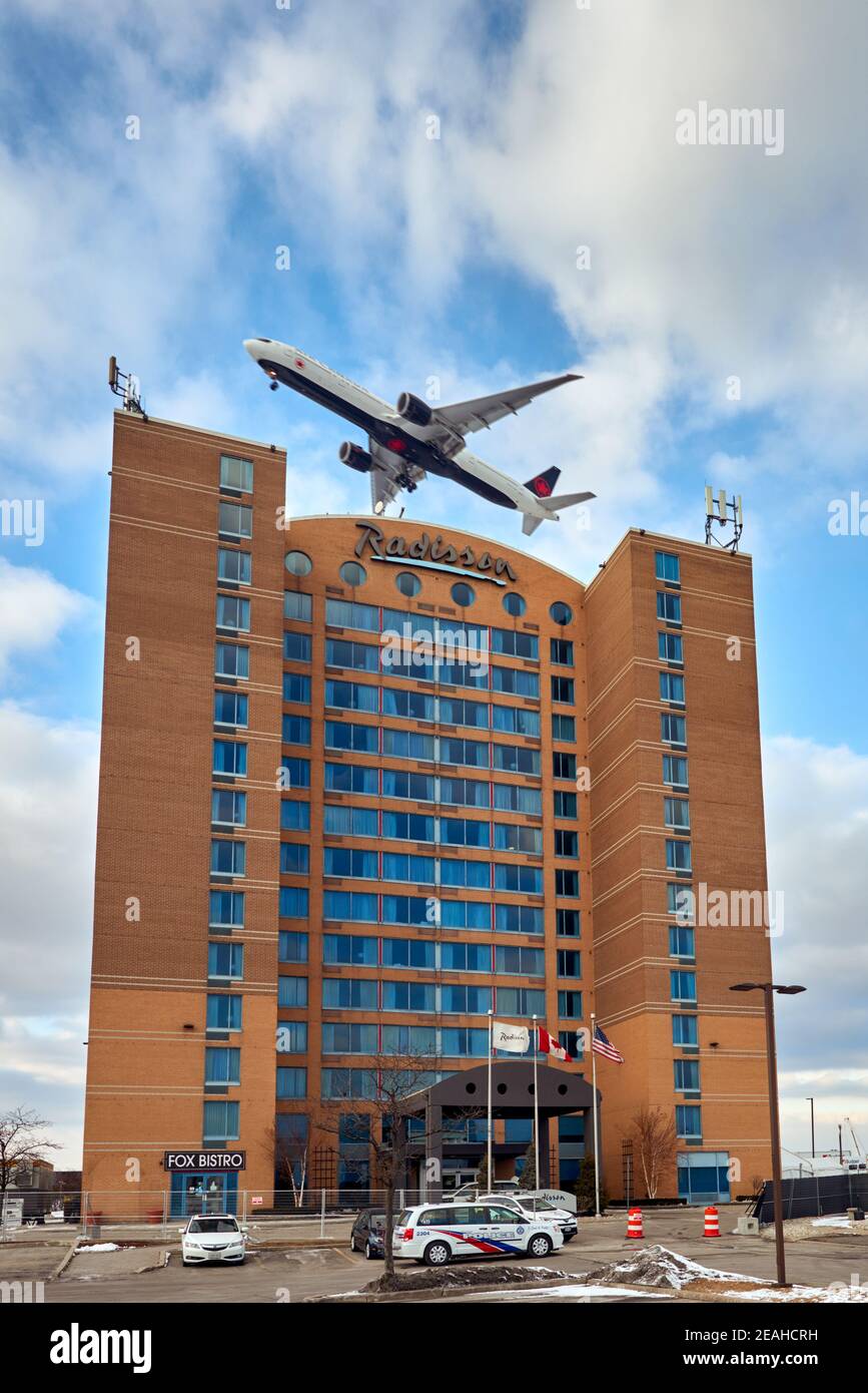 Air Canada plane over one of the hotels at Pearson airport designed to be a COVID-19 quarantine facility. Stock Photo