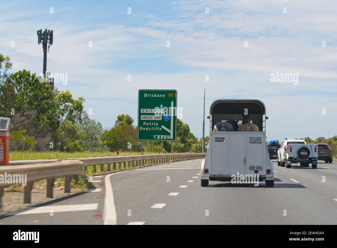 Brisbane, Qld, Australia - February 07, 2021: Driving on highway behind a horse trailer Stock Photo