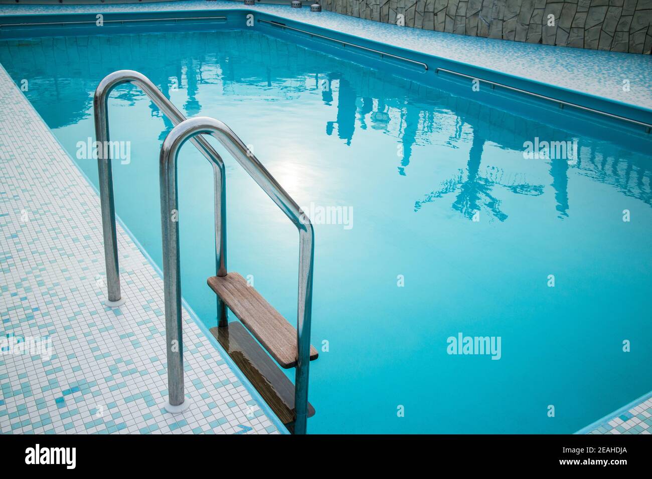 Grab bars ladder in blue the swimming pool Stock Photo - Alamy