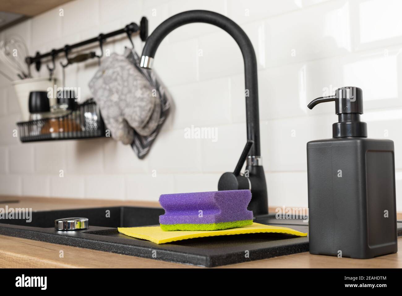 Close up picture of a clean wooden kitchen countertop and black sink ...
