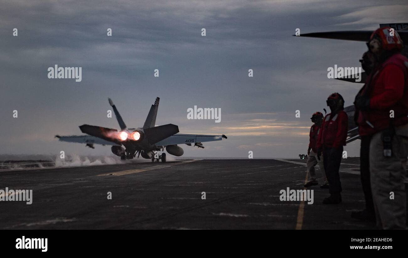 Handout photo of An F/A-18E Super Hornet, assigned to the “Golden Warriors” of Strike Fighter Squadron (VFA) 87, launches from the flight deck of the USS Theodore Roosevelt (CVN 71) while conducting dual-carrier operations with the Nimitz Carrier Strike Group in the South China Sea February 9, 2021. Two US Navy aircraft carrier strike groups began operations in the disputed waters of the South China Sea on Tuesday, the latest show of naval capabilities by the Biden administration as it pledges to stand firm against Chinese territorial claims.The carriers USS Theodore Roosevelt and USS Nimitz a Stock Photo