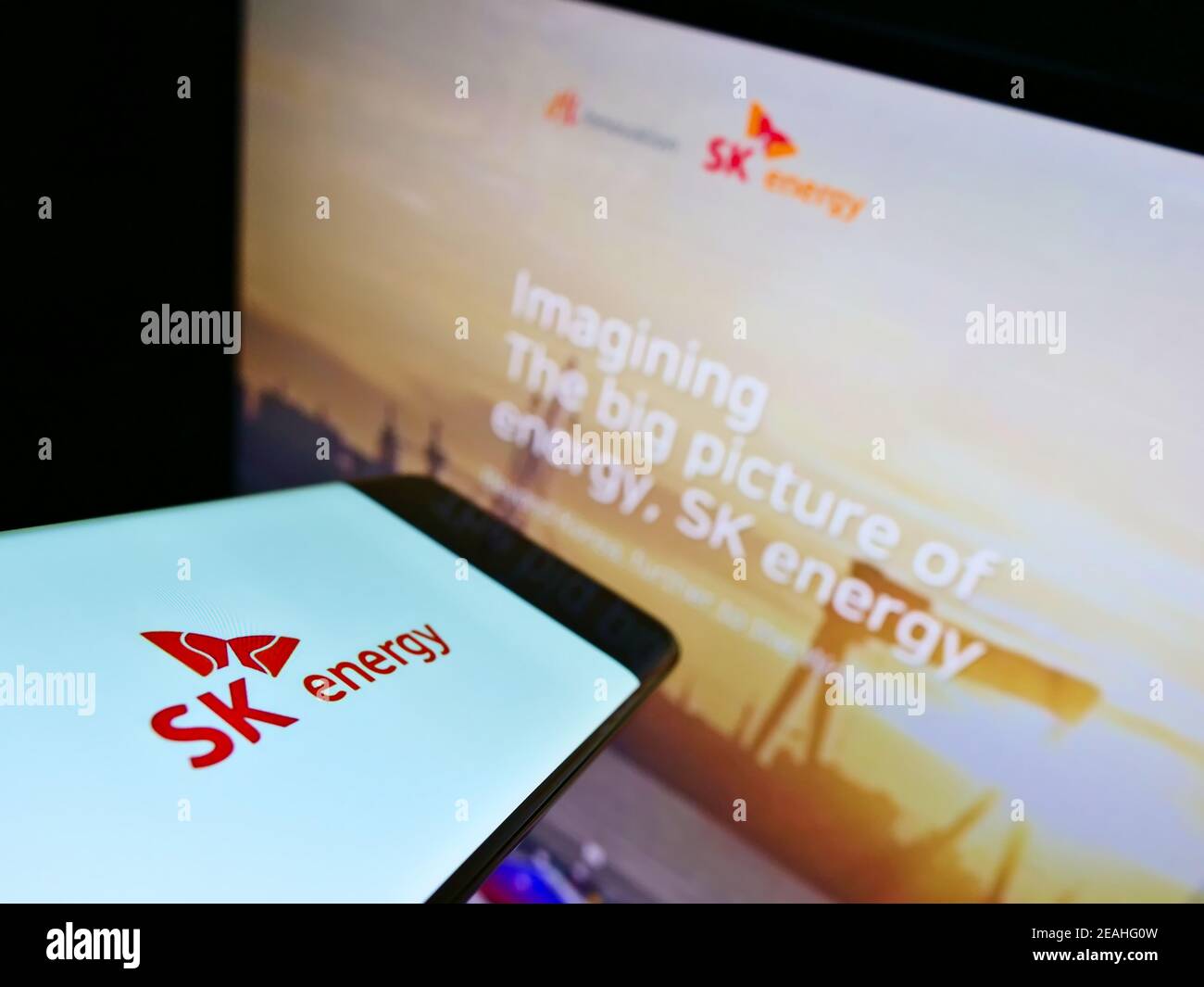 Mobile phone with business logo of South Korean oil company SK Energy on screen in front of web page. Focus on center of cellphone display. Stock Photo