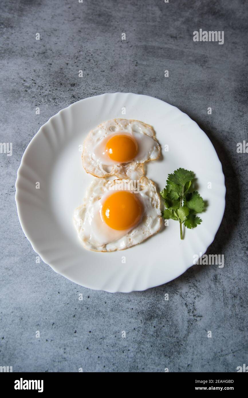 Egg poach sunny side up a healthy food ingredient on a plate Stock