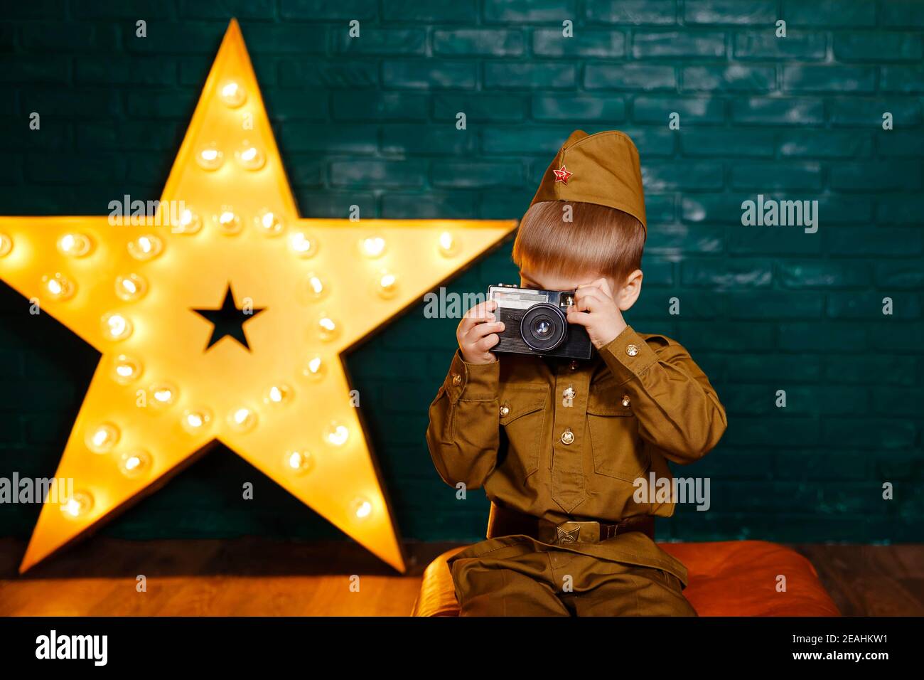 Soldier with film camera. Photographer with camera in his hands. Stock Photo