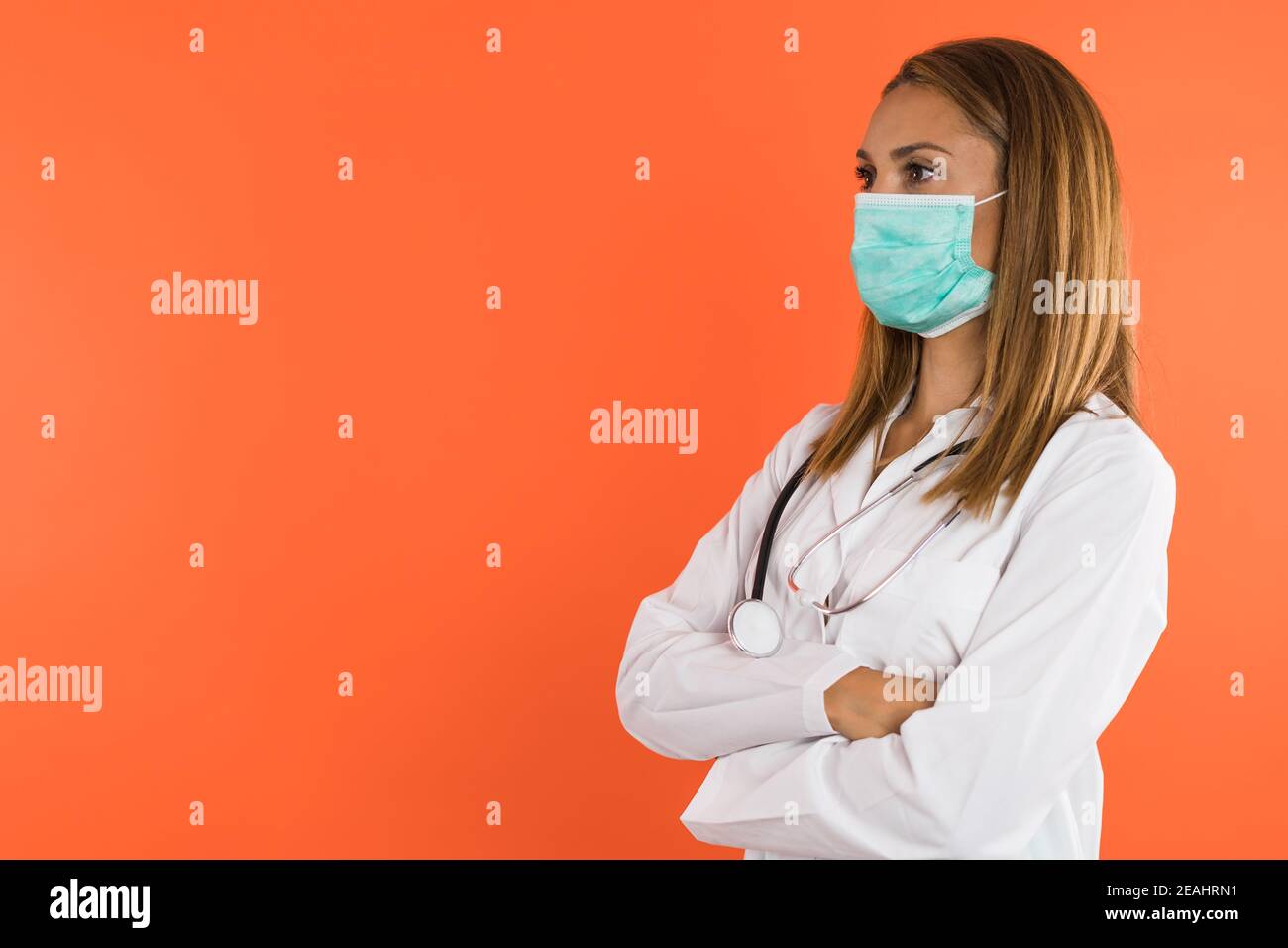 Profile of woman doctor with facemask looking on the side with copyspace Stock Photo