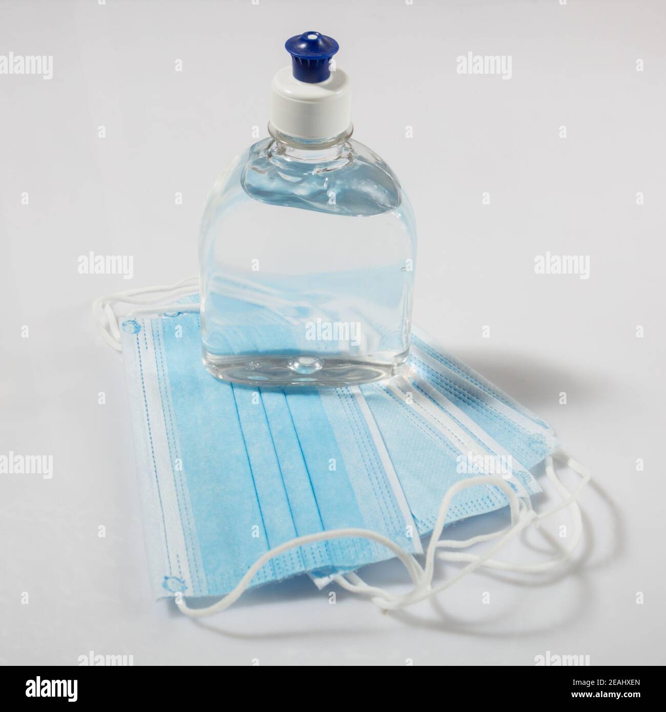 Alcohol gel hand sanitizer and disposable hygienic mask Stock Photo