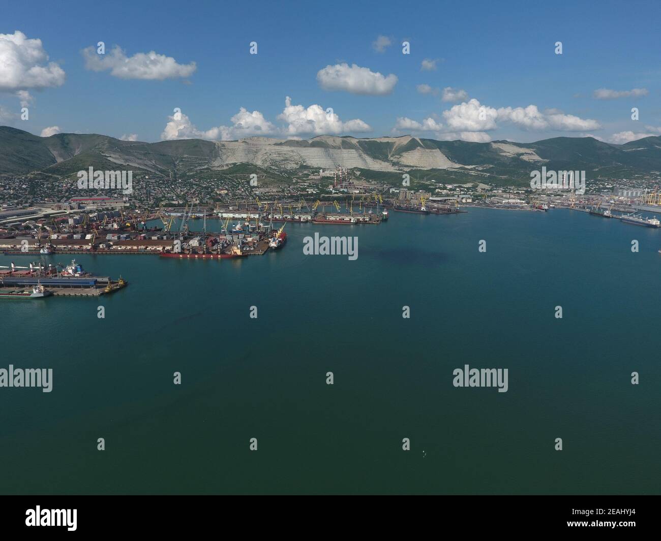 Industrial seaport, top view. Port cranes and cargo ships and barges. Stock Photo