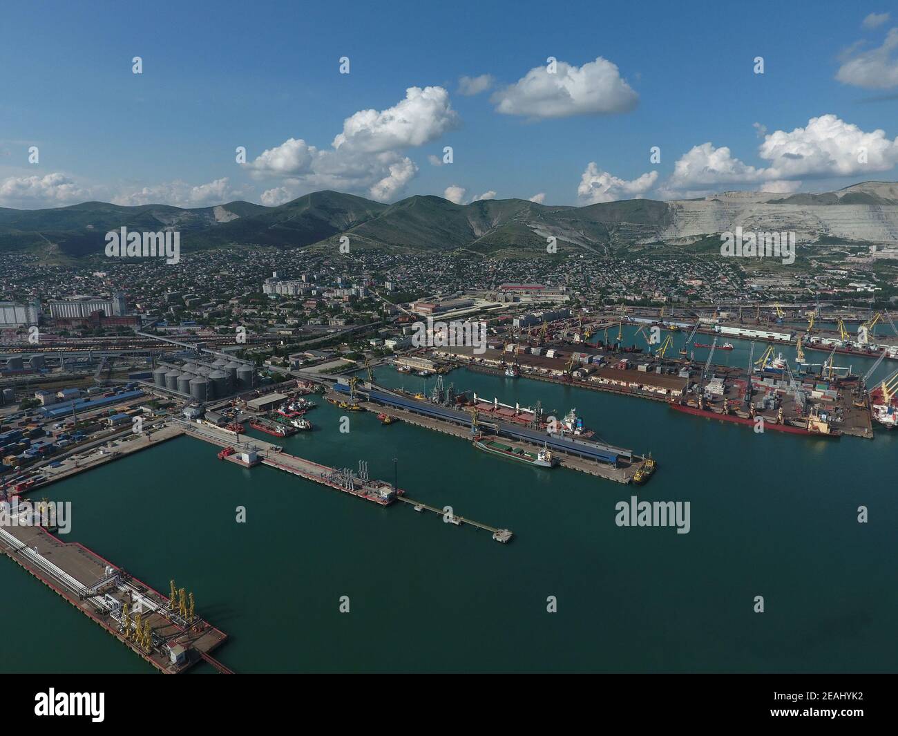 Industrial seaport, top view. Port cranes and cargo ships and barges. Stock Photo