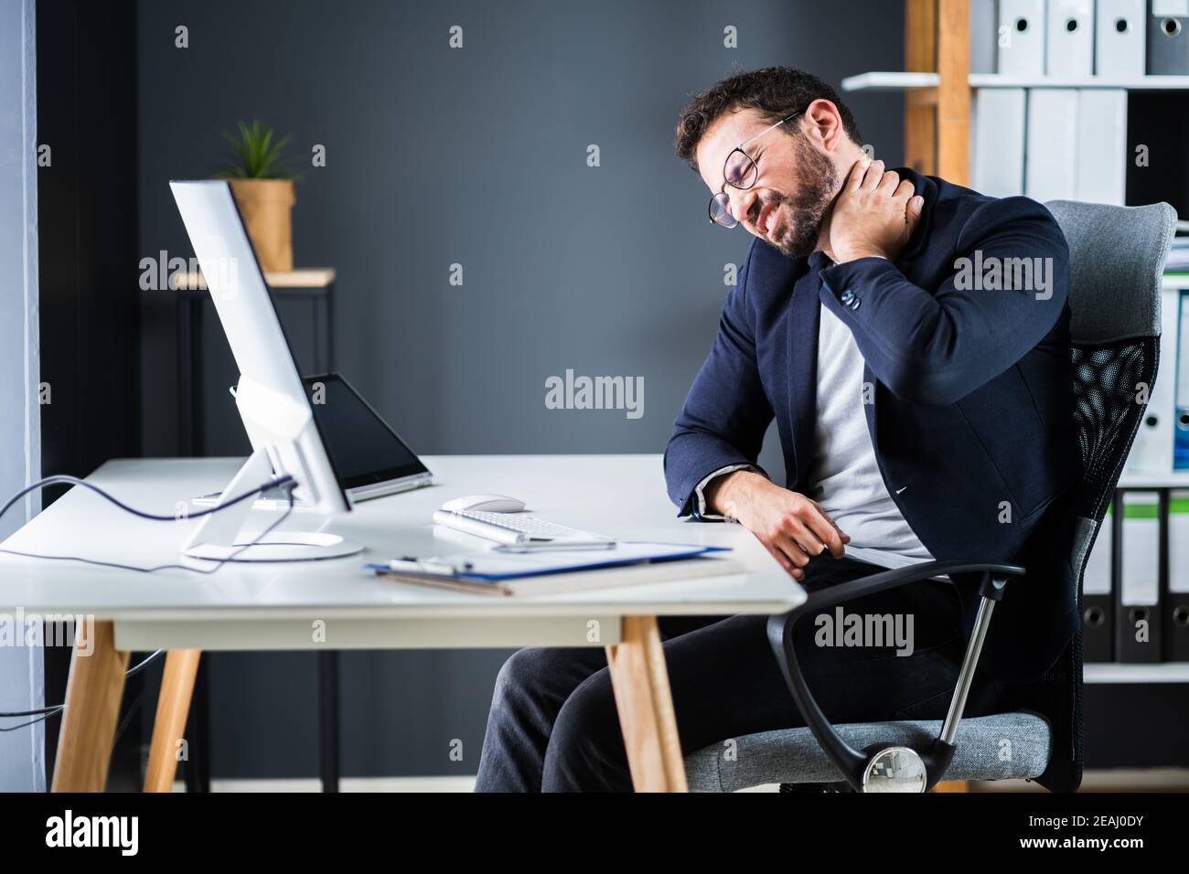 Young Man With Tense Neck Pain Stock Photo