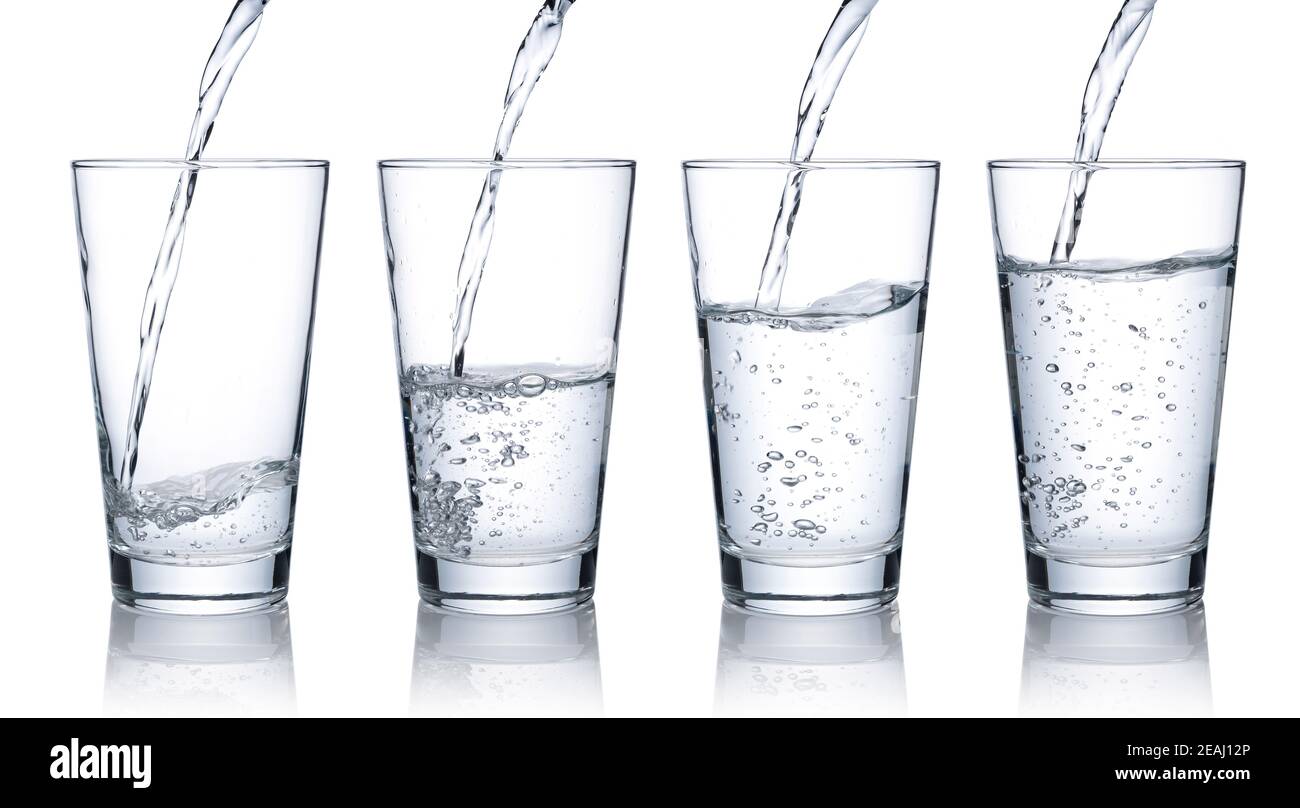 Pour water into a glass placed on a white background Stock Photo Alamy