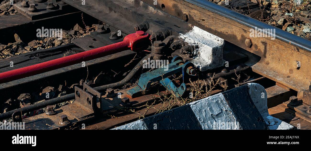 Close-up of the railway switch mechanism. The translation of the arrow. Stock Photo