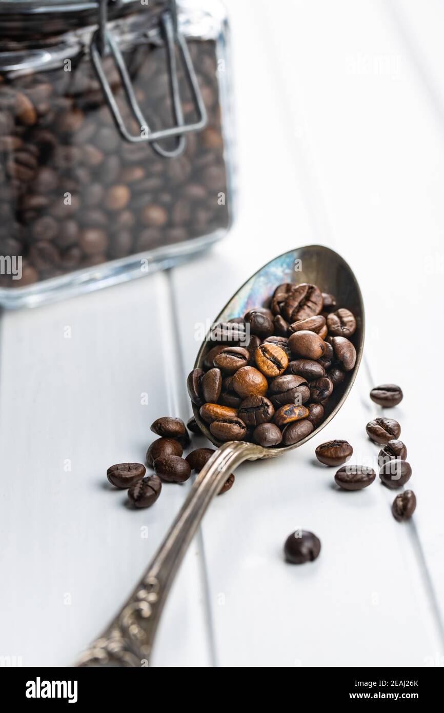 Roasted coffee beans in spoon Stock Photo Alamy
