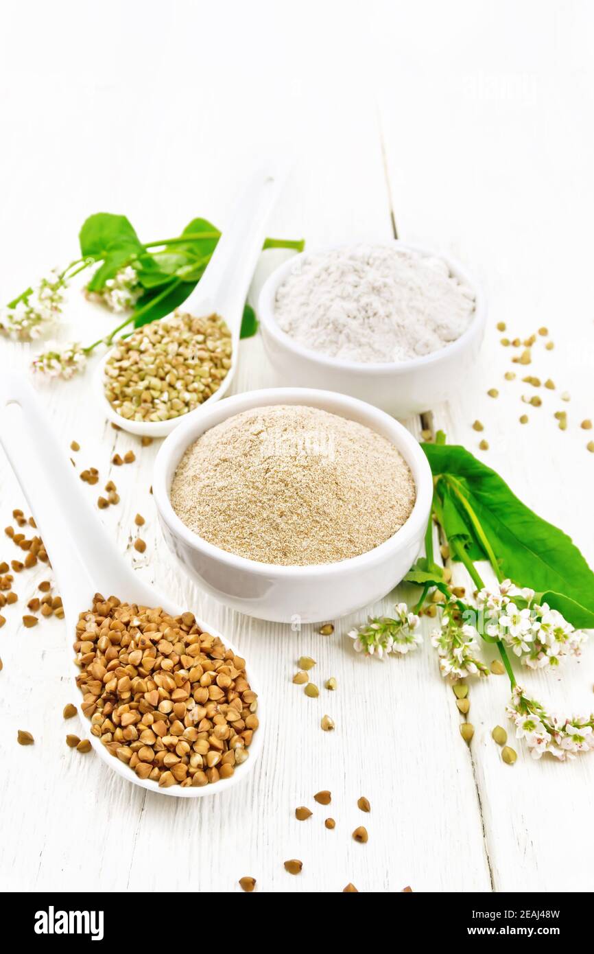 Flour buckwheat brown and green in bowls on light board Stock Photo Alamy