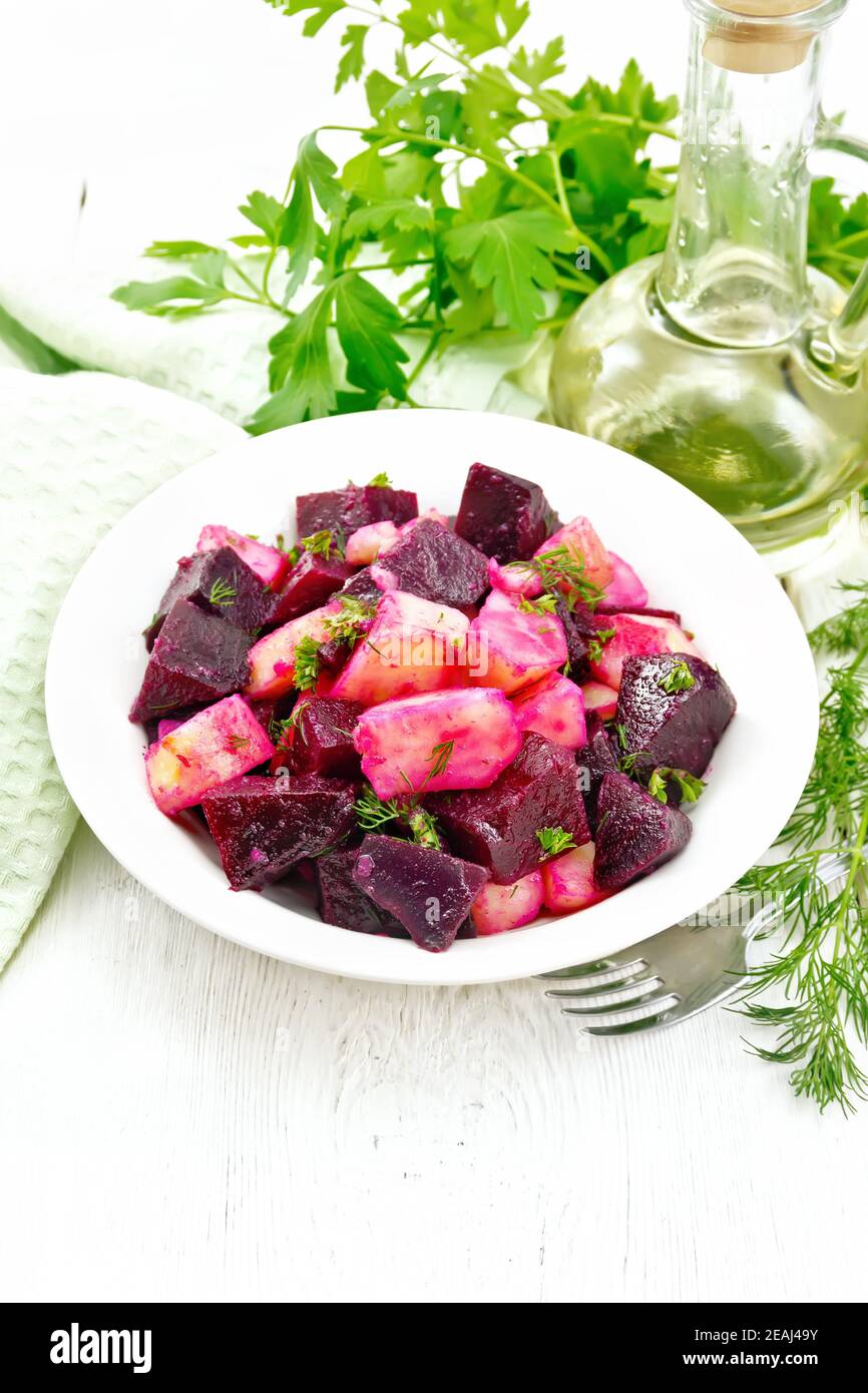 Salad of beets and potatoes in plate on light board Stock Photo