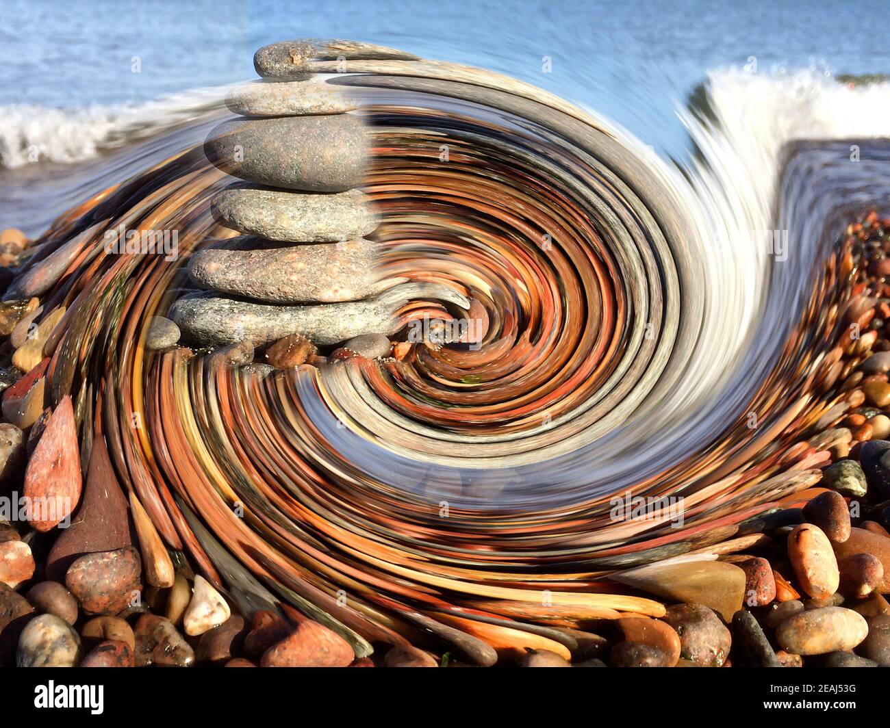 Zen stones on the beach in a spinning wheel Stock Photo