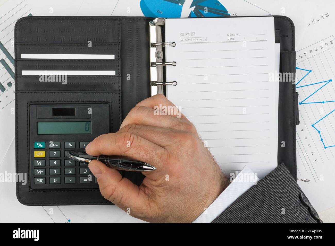 Businessman considers on the calculator Stock Photo