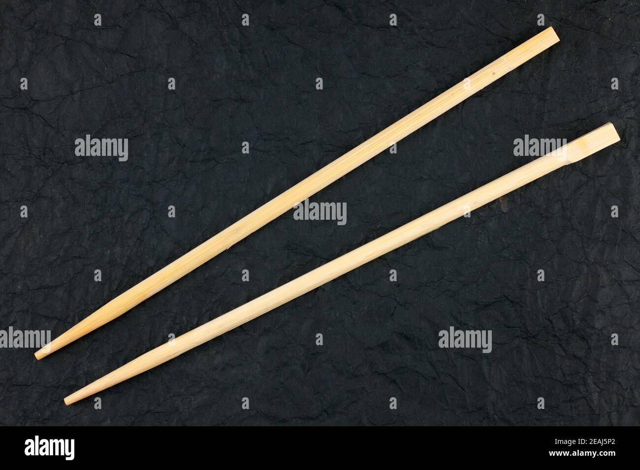 Chopsticks lay on a black napkin Stock Photo Alamy