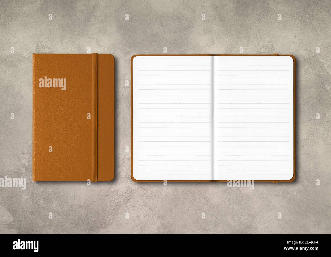 Leather closed and open lined notebooks on concrete background Stock Photo