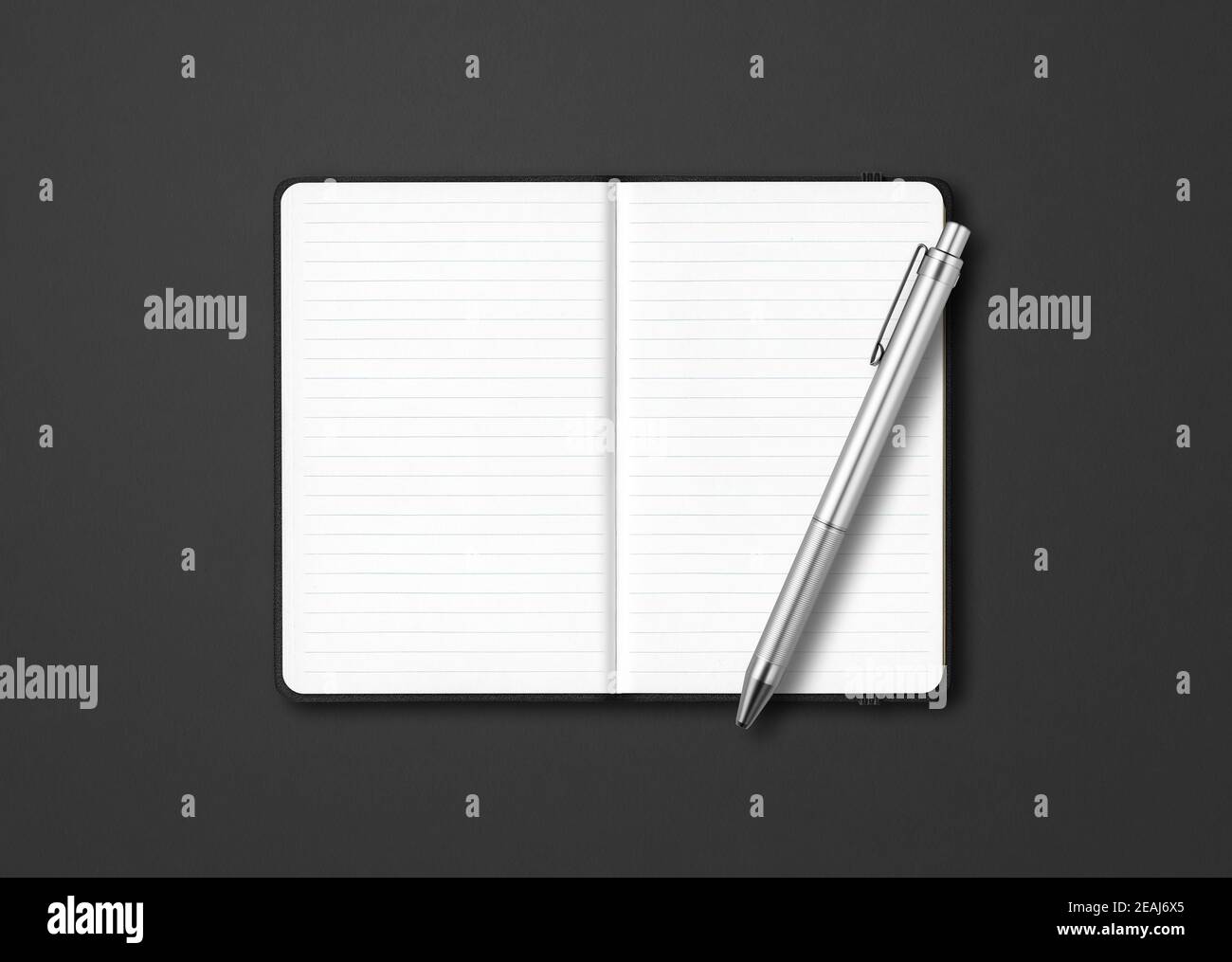 Black open lined notebook with a pen isolated on dark background Stock Photo