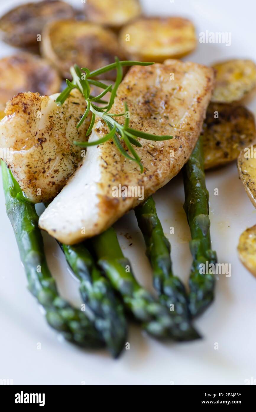 cod with green aparagus and roasted potatoes Stock Photo