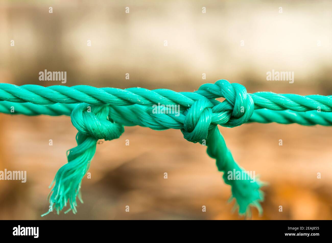 Rope tie knot Closeup. Rope with a two tied knot in the middle isolated  from background.