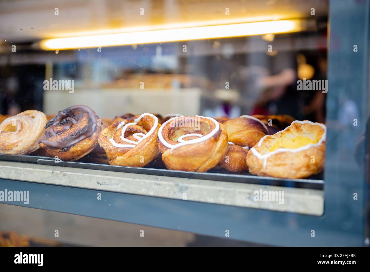 Danish Pastries with Chocolate and Cream Through the Window of a Bakery ...