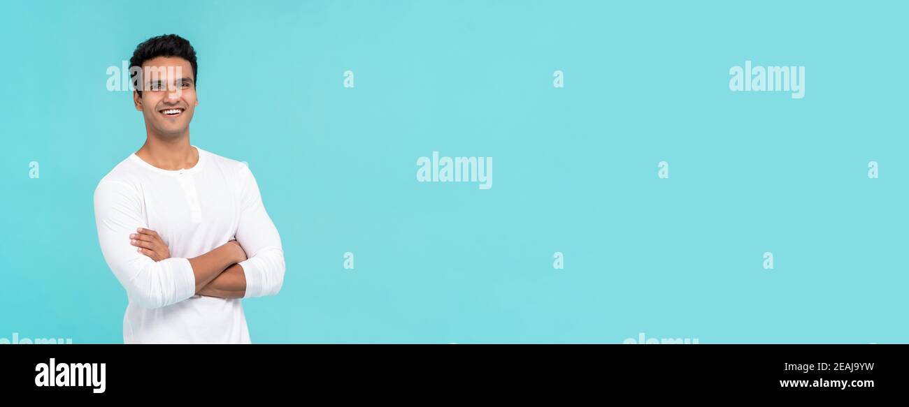 Smiling happy Indian man with arms crossed in plain white t-shirt ...